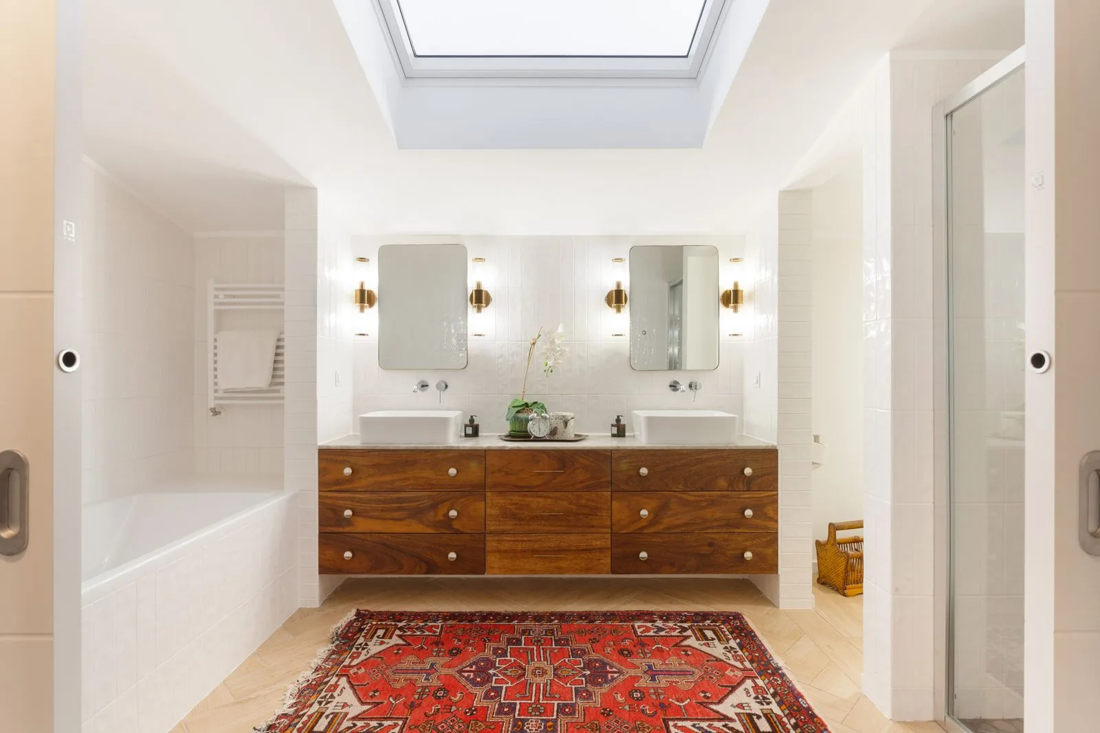 After — master bathroom with walnut vanity and skylight — Riviera villa renovation Cascais by Maya's Homes